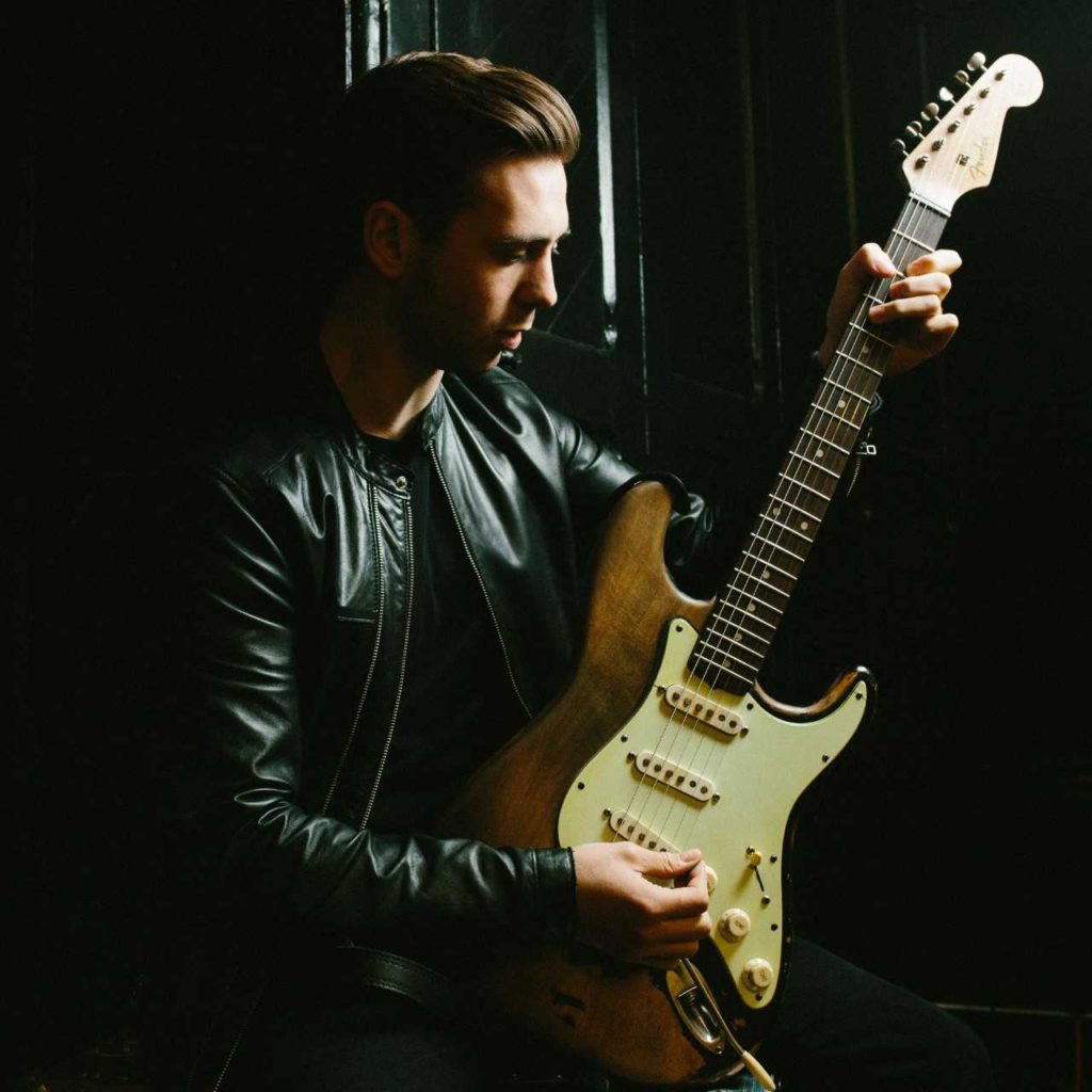 image of Laurence Jones holding his guitar