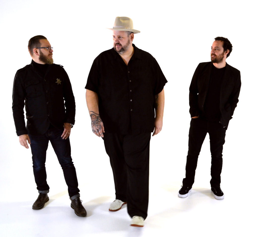 image of Big Boy Bloater & The LiMiTs dressed in black with a white background