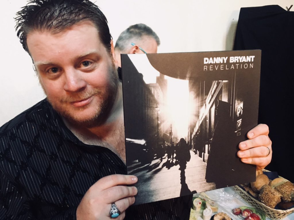 image of Danny Bryant holding his new record Revelation