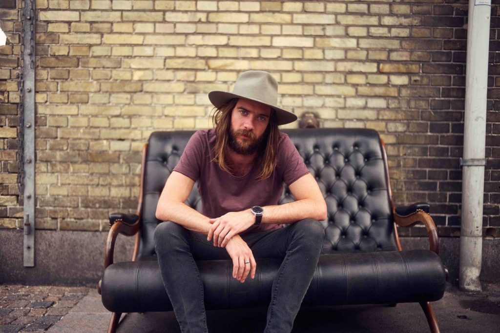 image of songwriter Jack Broadbent sitting on a couch