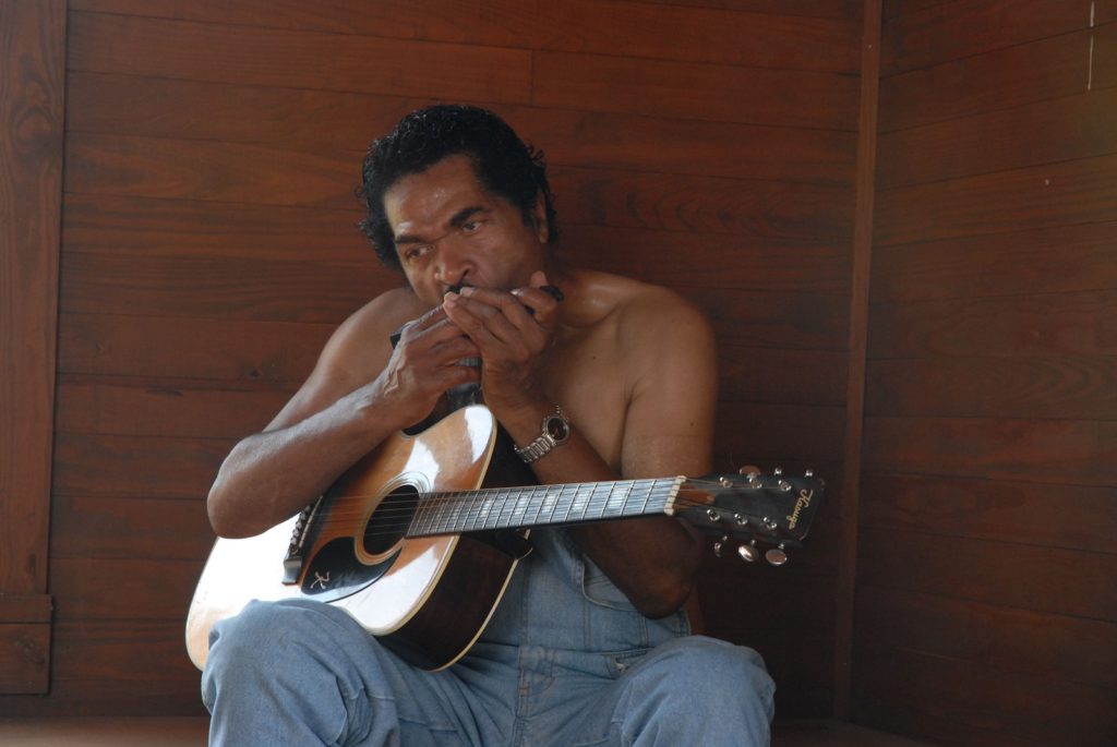 image of bobby rush bluesman with guitar and harp